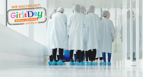 group of students in protective suits walking through a laboratory
